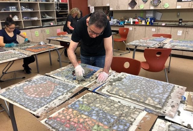 Jeff Wolfson grouting a mosaic