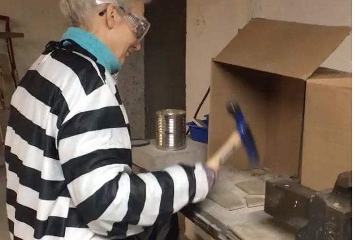 Mary dressed the part as she broke hundreds of tiles for use by NHAMS students.