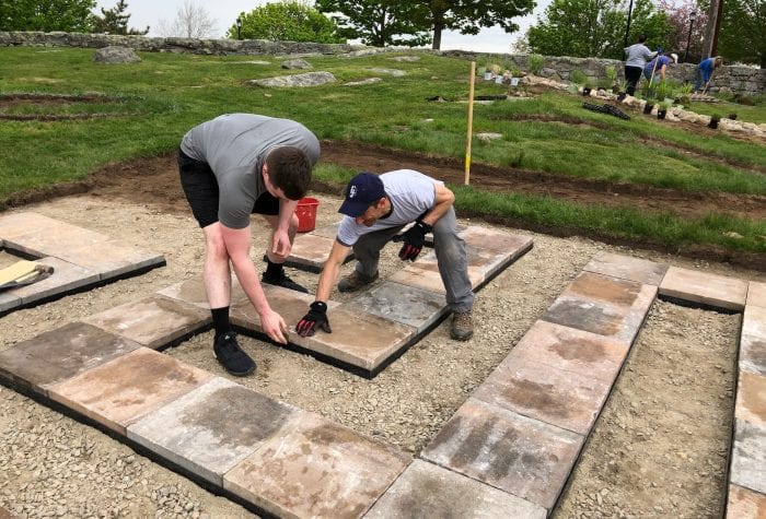 Jeff and CG Jacob set the final paver in place