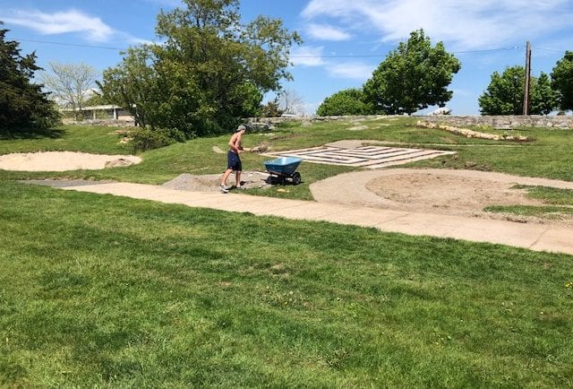 Christian preps a load of sand to haul uphill to the site of the rowboat