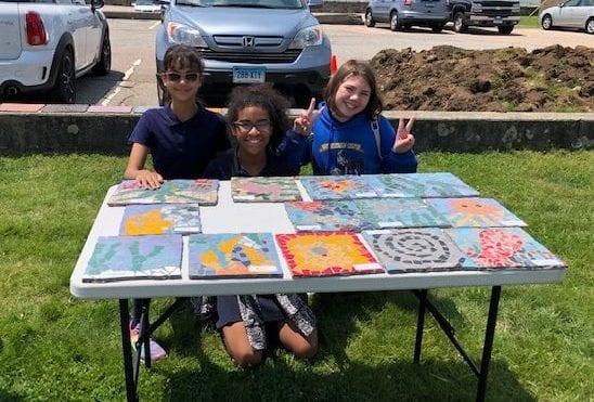 Students in front of some of their mosaics